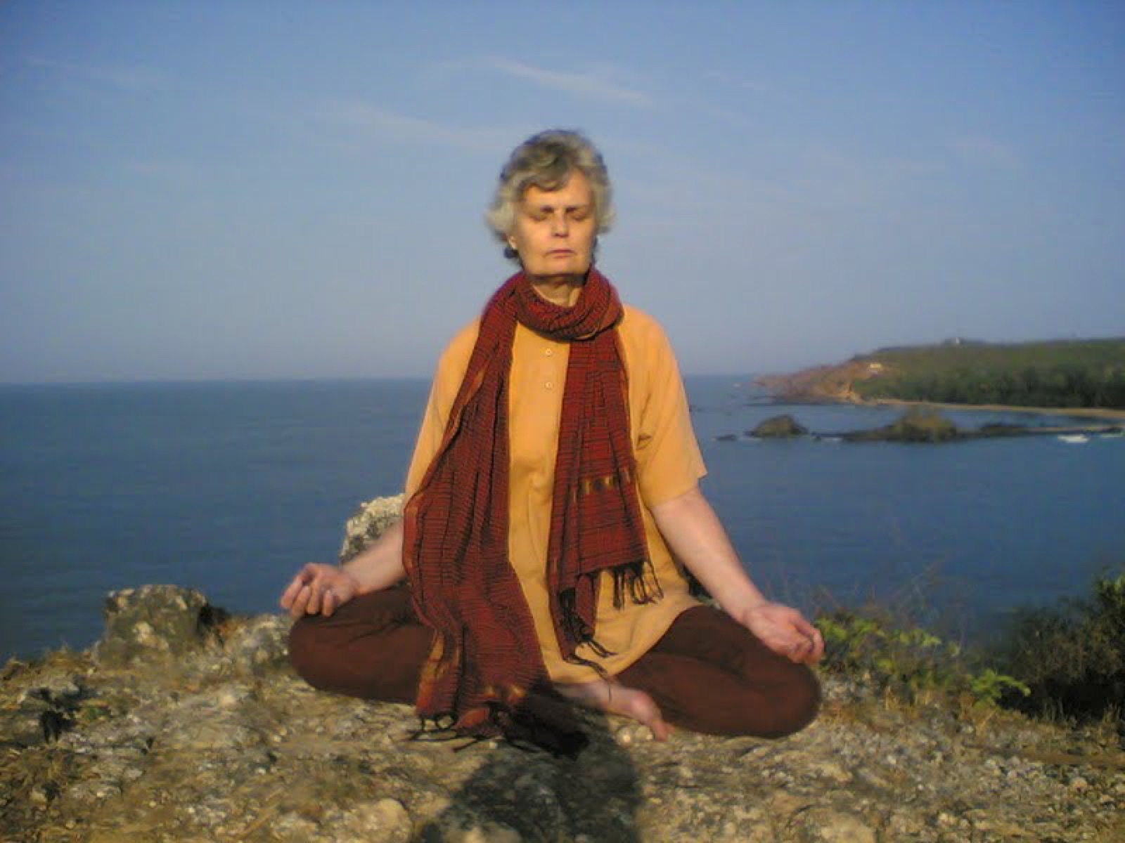 Swamiji in meditation on the cliffs above the sea