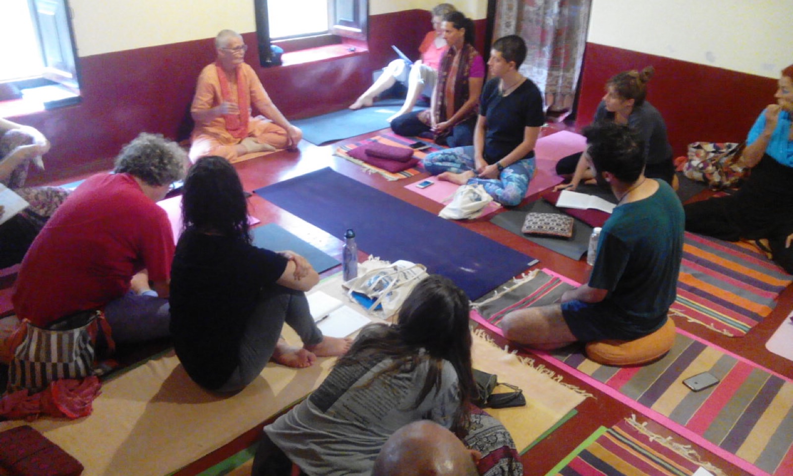 Swamiji teaching a Yoga Nidra class in the hall