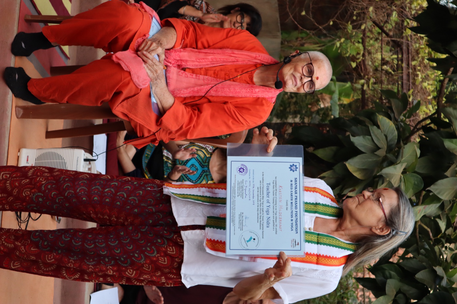 Swamiji presenting a teacher-training certificate