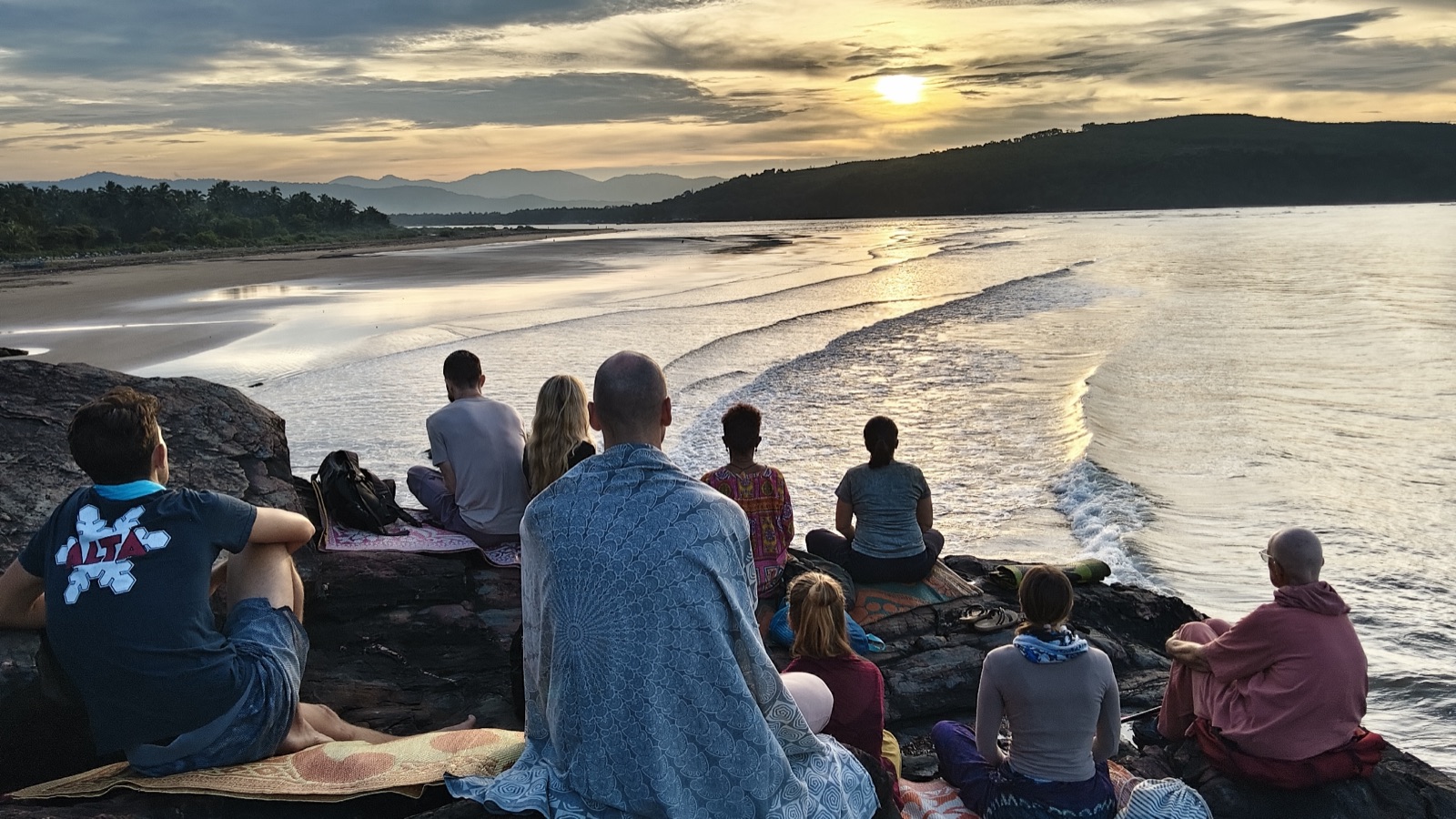 Sunrise meditation on the rocks above the sea
