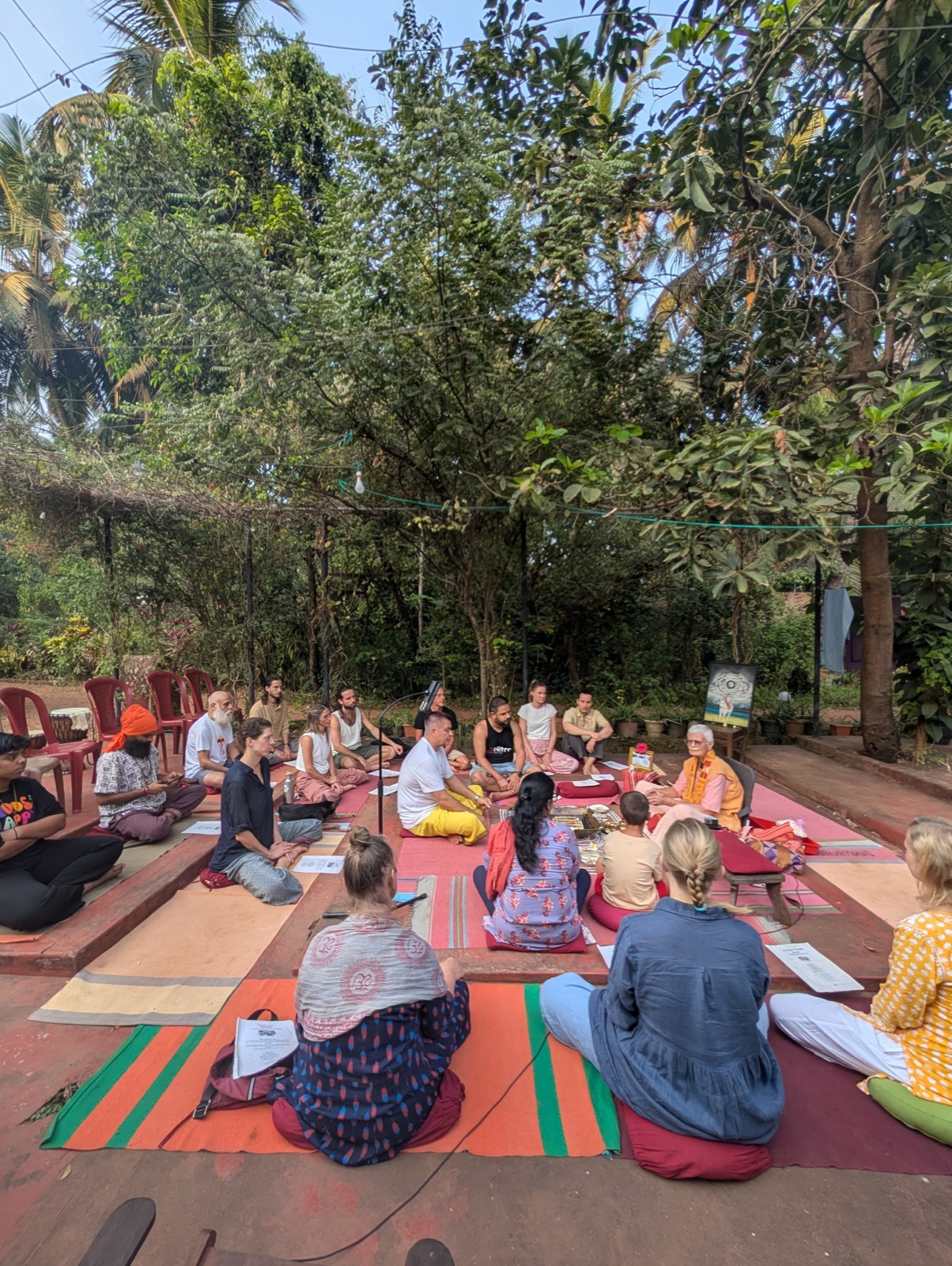 An outdoor satsang under the trees