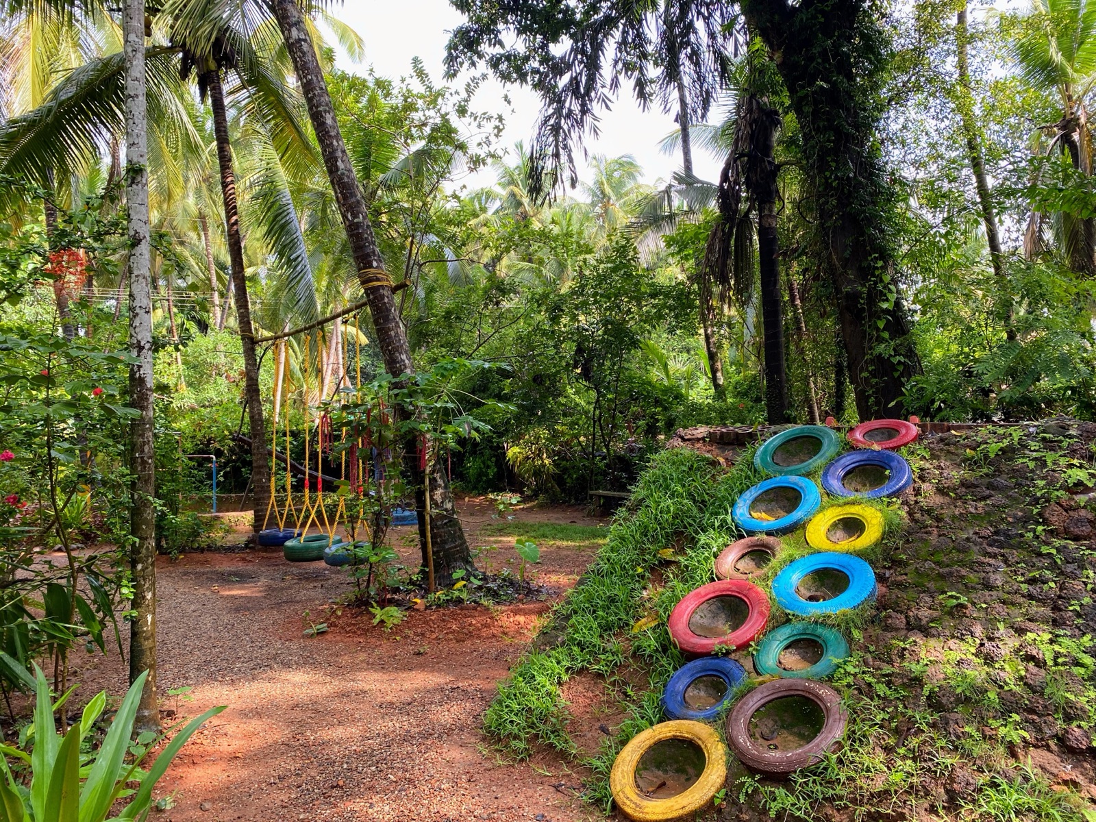 The tyre climbing wall and swings of the adventure playground
